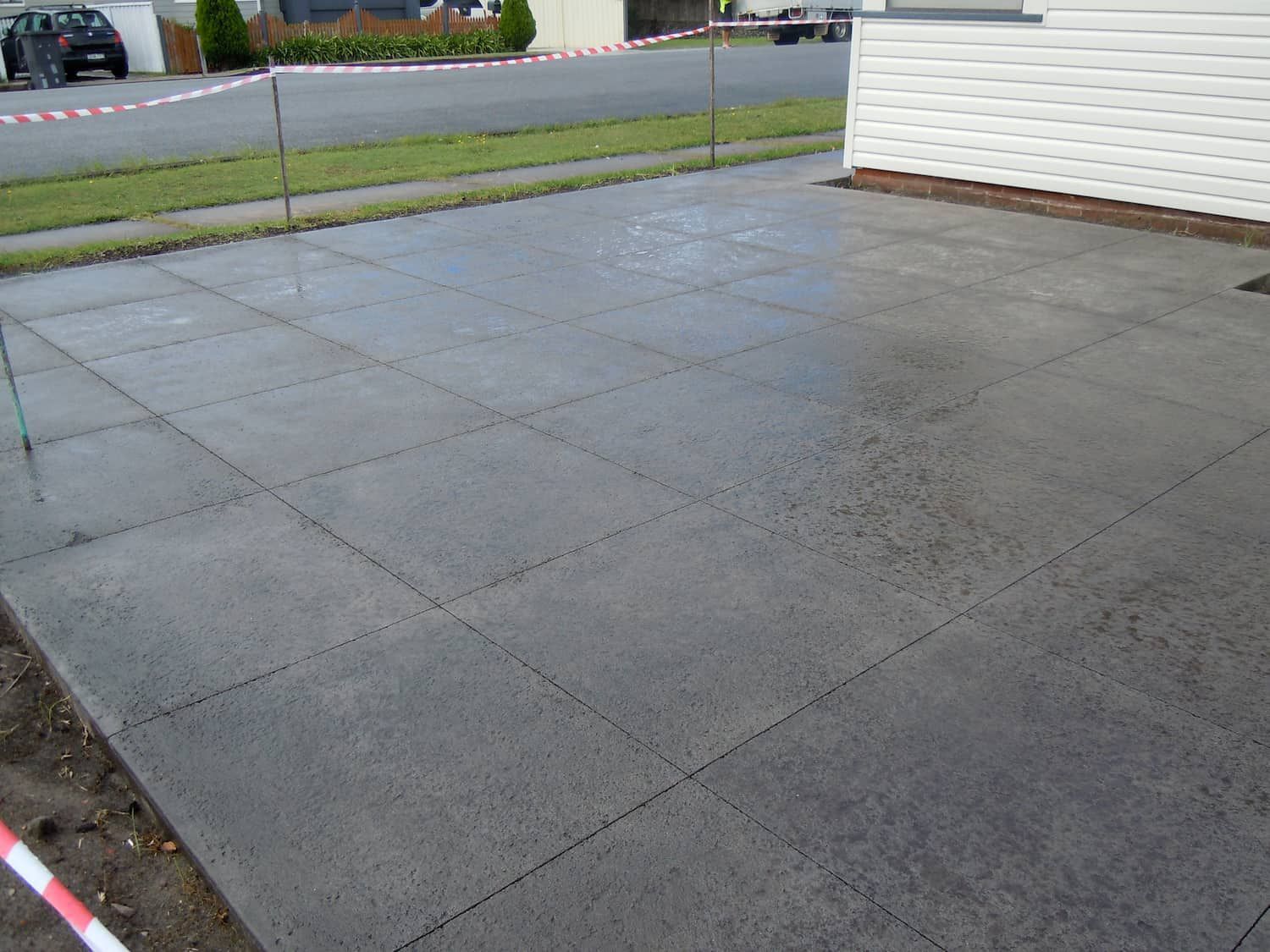 A Concrete Driveway Is Being Built In Front Of A House — Tuncote Concrete Constructions in Anna Bay, NSW