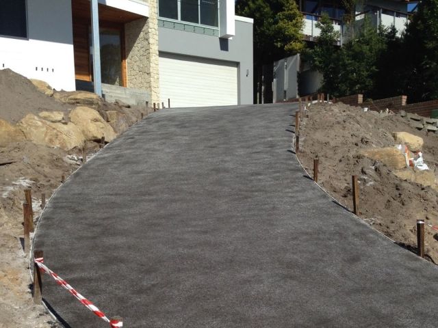 A Concrete Driveway Is Being Built In Front Of A House — Tuncote Concrete Constructions in Raymond Terrace, NSW