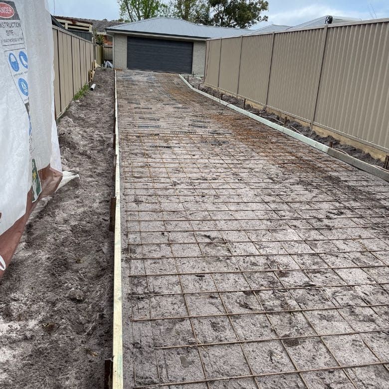 A Concrete Driveway Is Being Built In Front Of A House — Tuncote Concrete Constructions in Nelson Bay, NSW