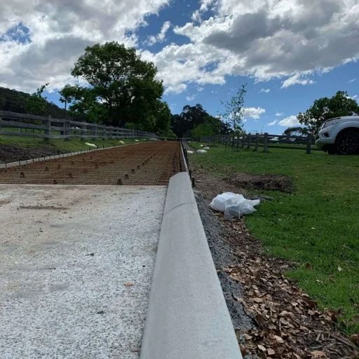 A White Car Is Parked On The Side Of A Dirt Road — Tuncote Concrete Constructions in Raymond Terrace, NSW