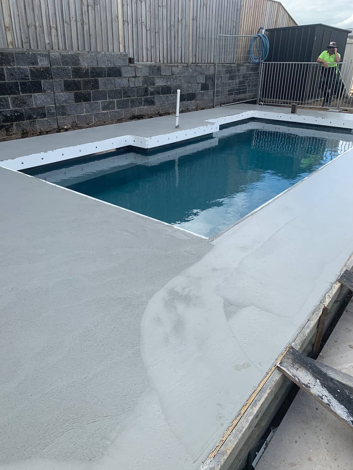 A Large Swimming Pool Is Being Built In A Backyard — Tuncote Concrete Constructions in Anna Bay, NSW