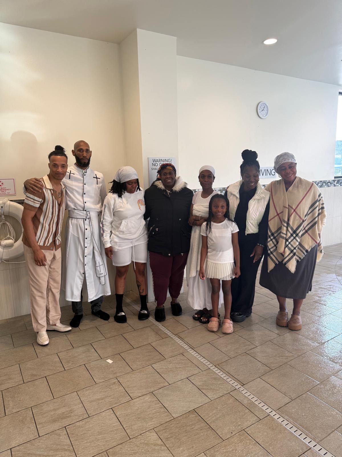 A group of people are posing for a picture in a bathroom.