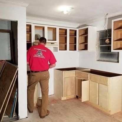 A man in a red shirt is working in a kitchen