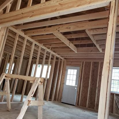A house is being built with wooden beams and a door.
