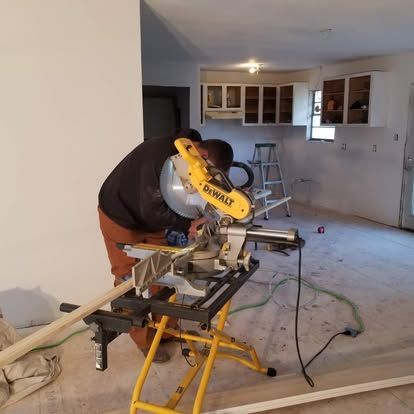 A man is using a dewalt circular saw in a kitchen