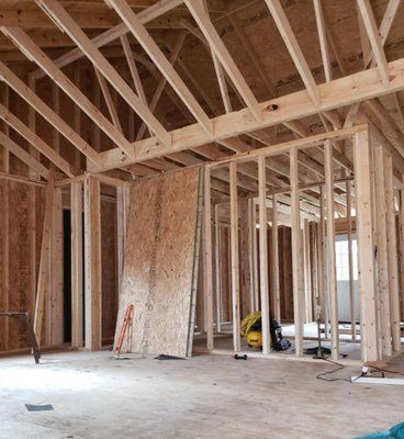 An empty living room with hardwood floors and a fireplace.