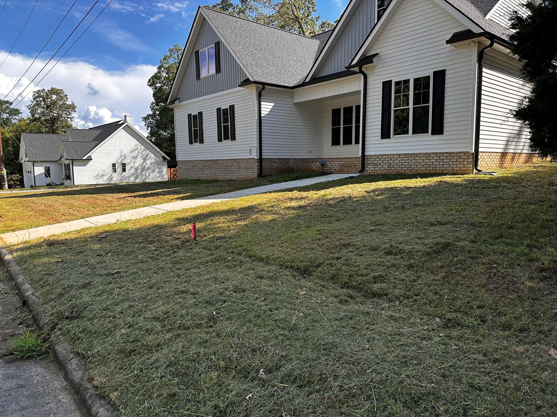 A couple of houses are sitting next to each other on a hill.