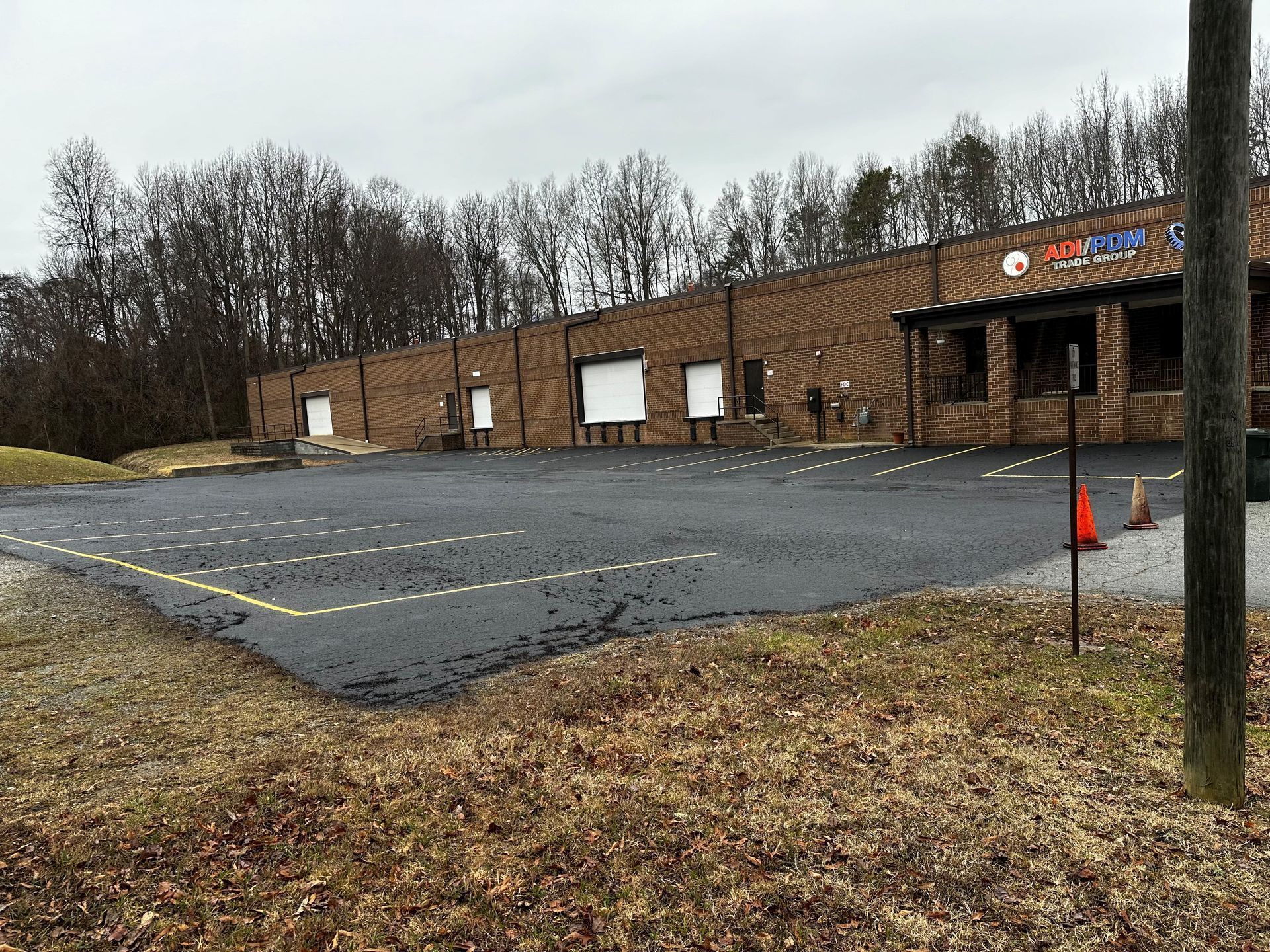 A large brick building with a parking lot in front of it.