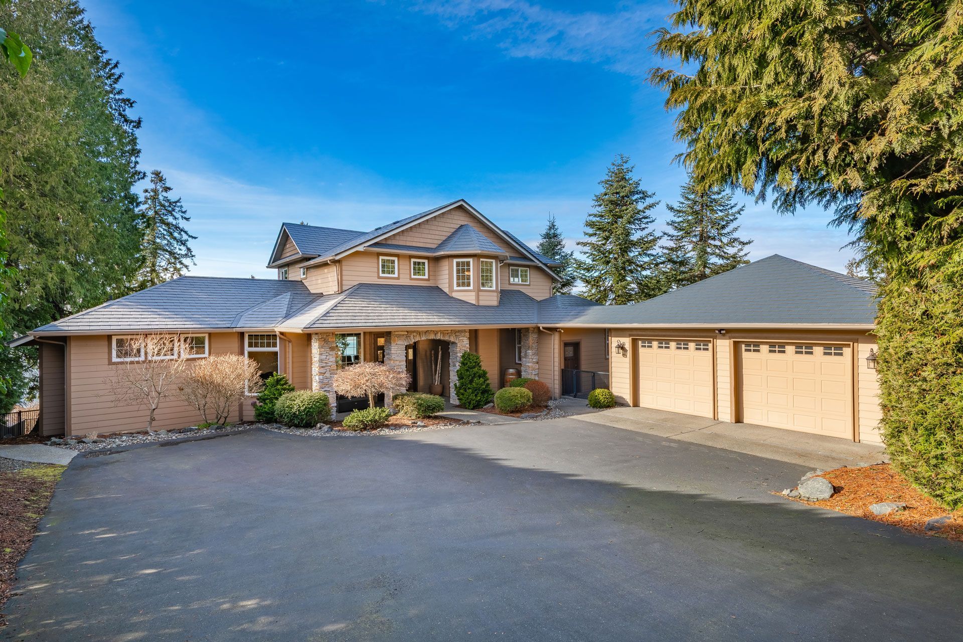 A large house with a lot of garage doors is for sale.