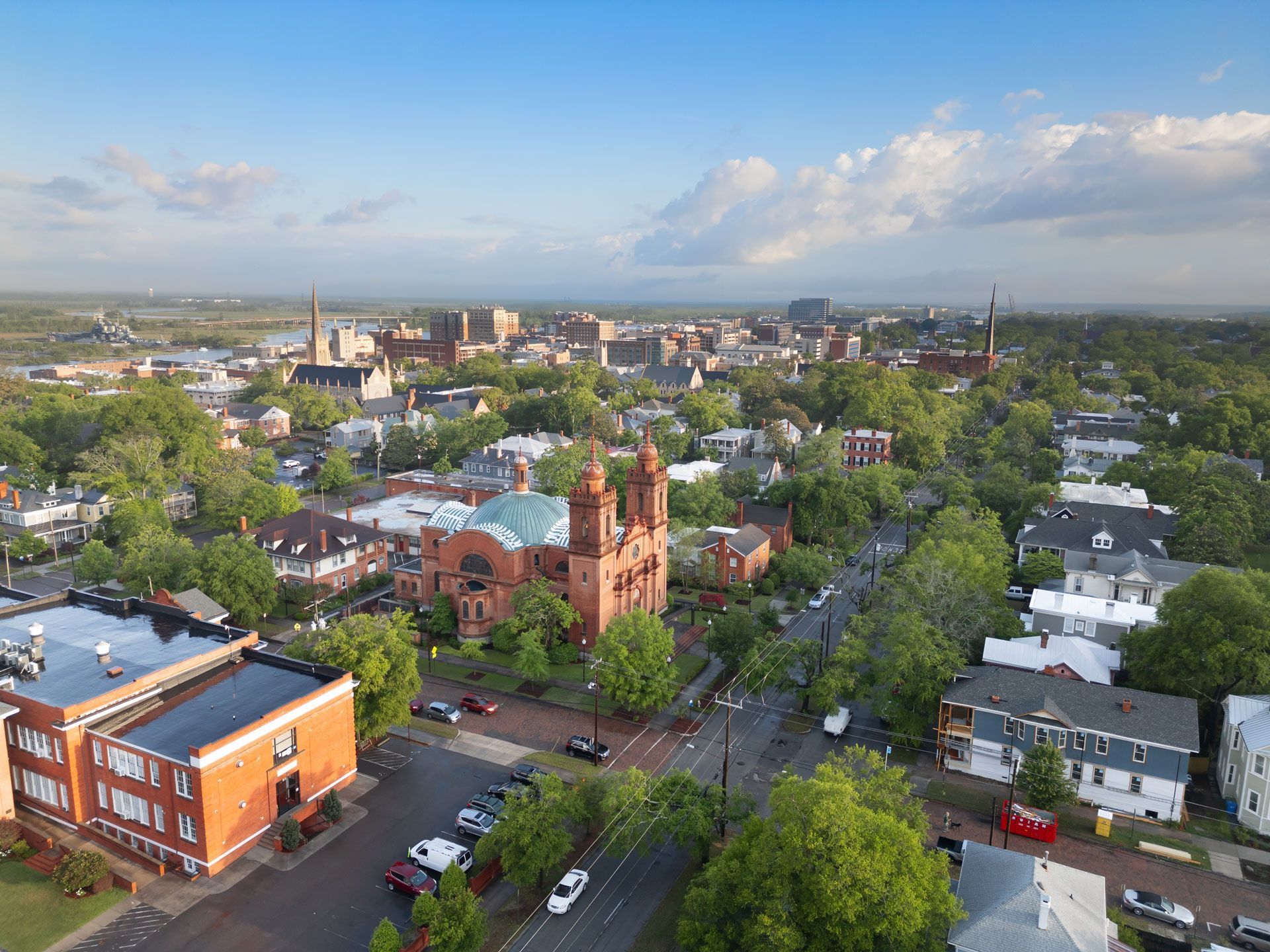 An aerial view of a city with a church in the middle of it