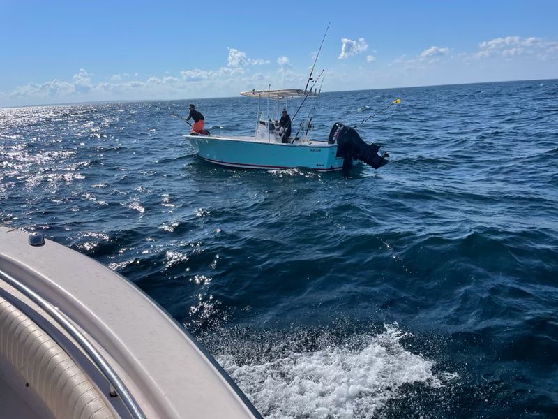 A boat is floating on top of a large body of water.