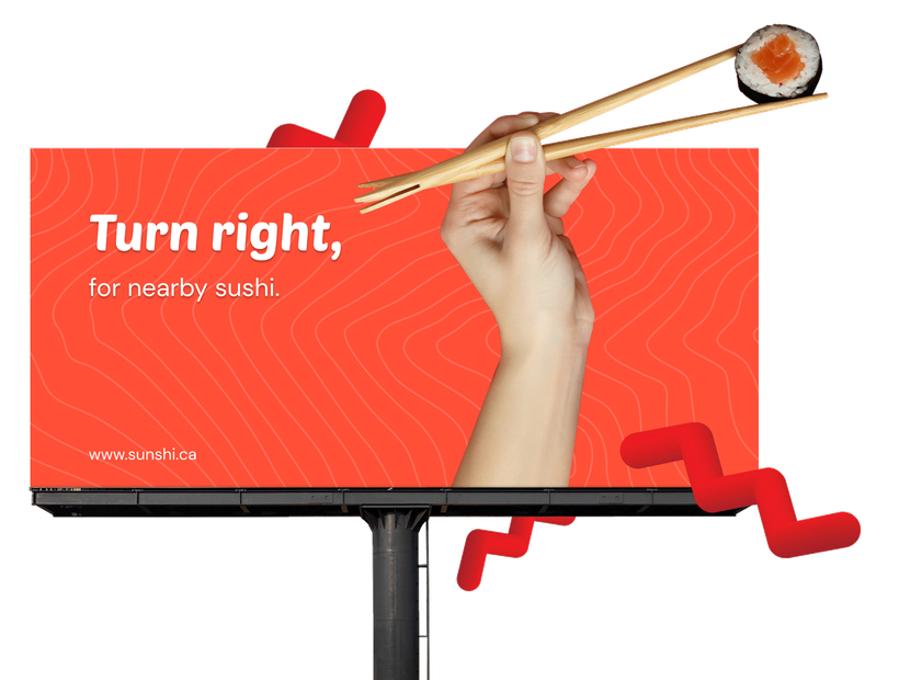 Billboard graphic that says turn right, for nearby sushi with a hand holding chopsticks and sushi