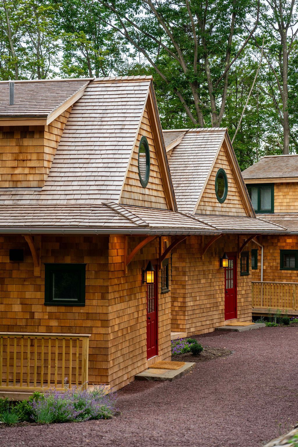 A row of wooden cabins with red doors and windows.