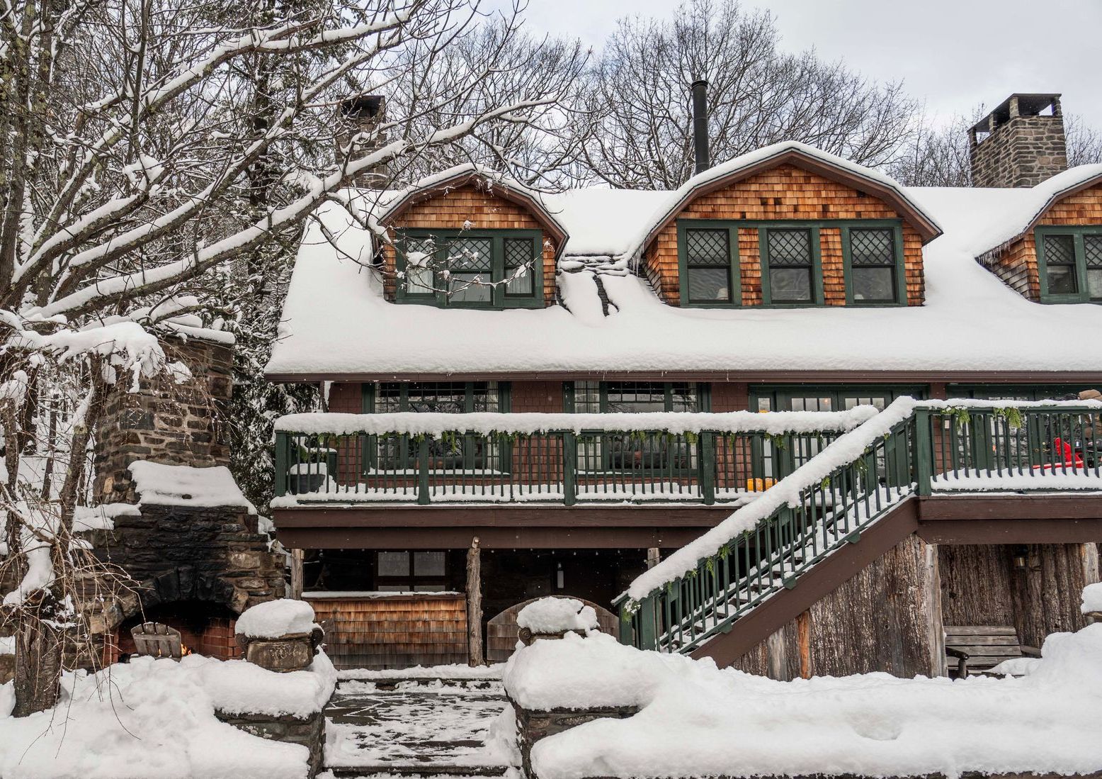 A snowy house with stairs leading up to it