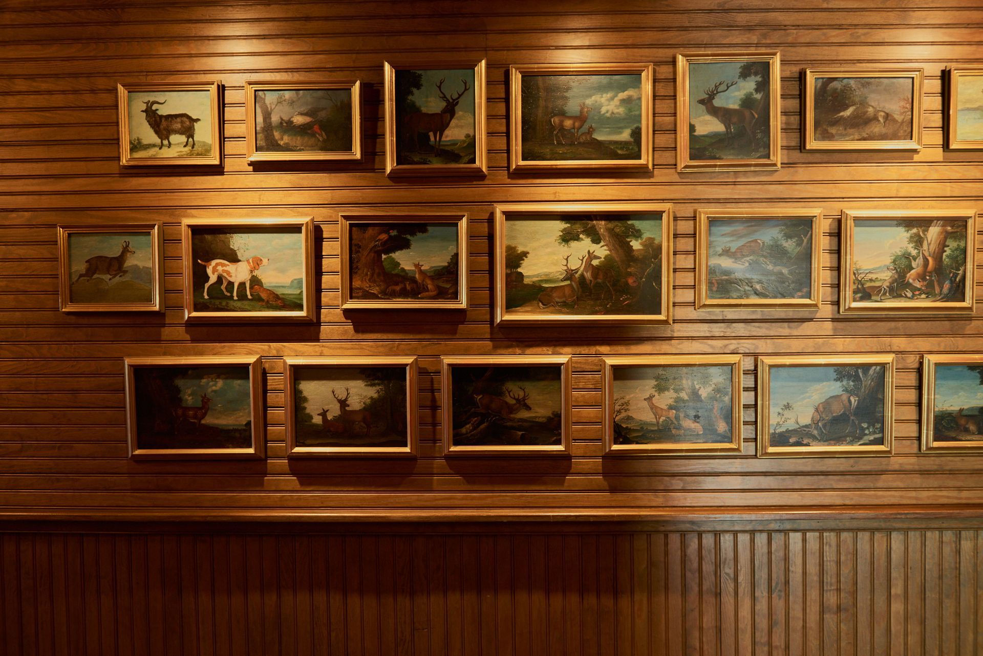 A wooden wall with a bunch of paintings on it