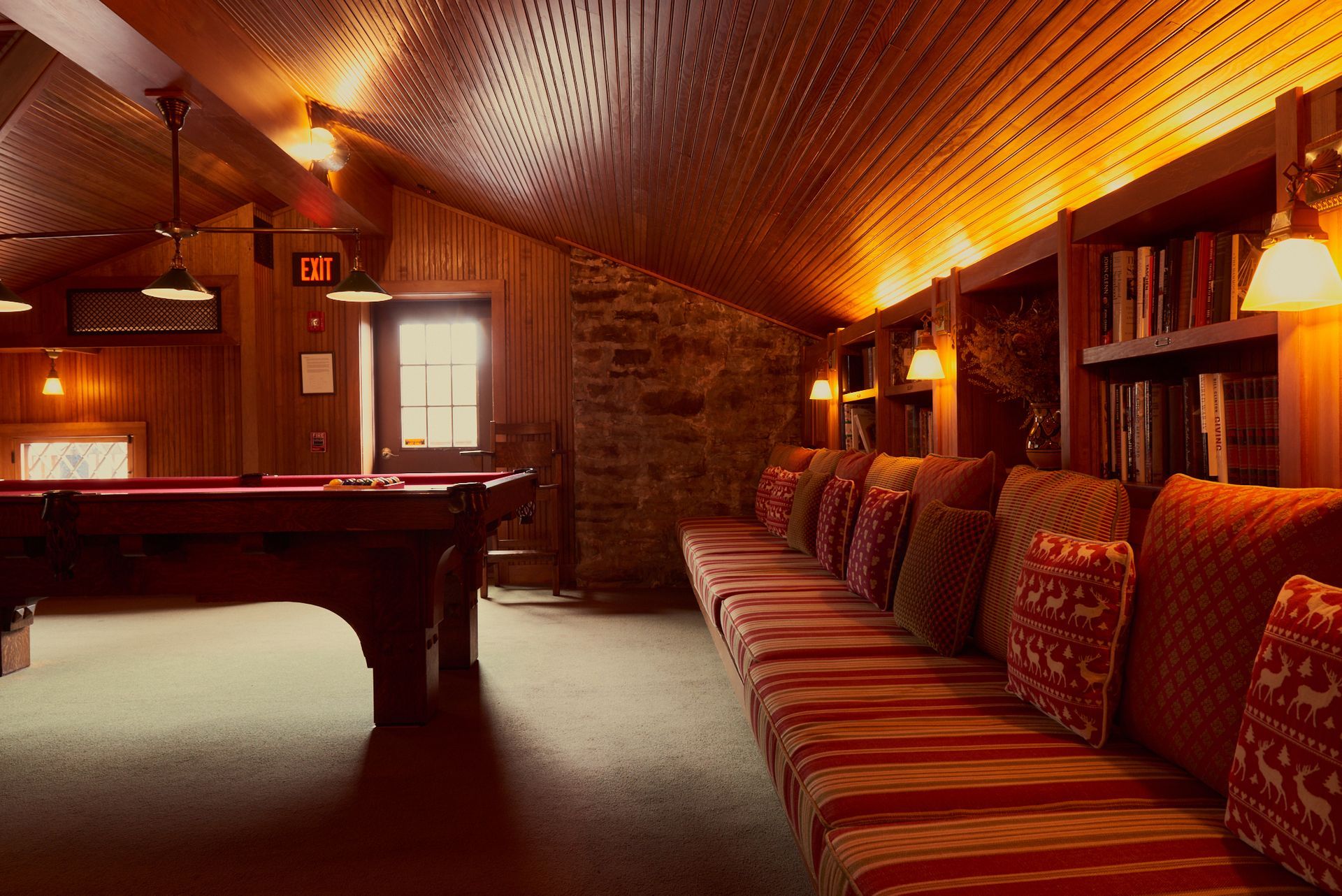 A room with a pool table and a couch