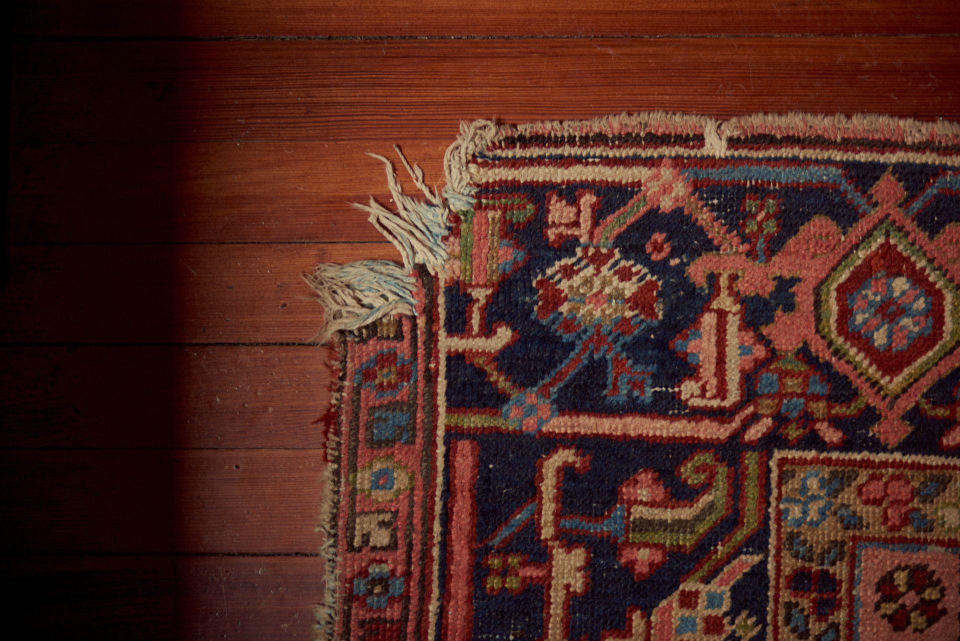 A rug is sitting on a wooden floor.