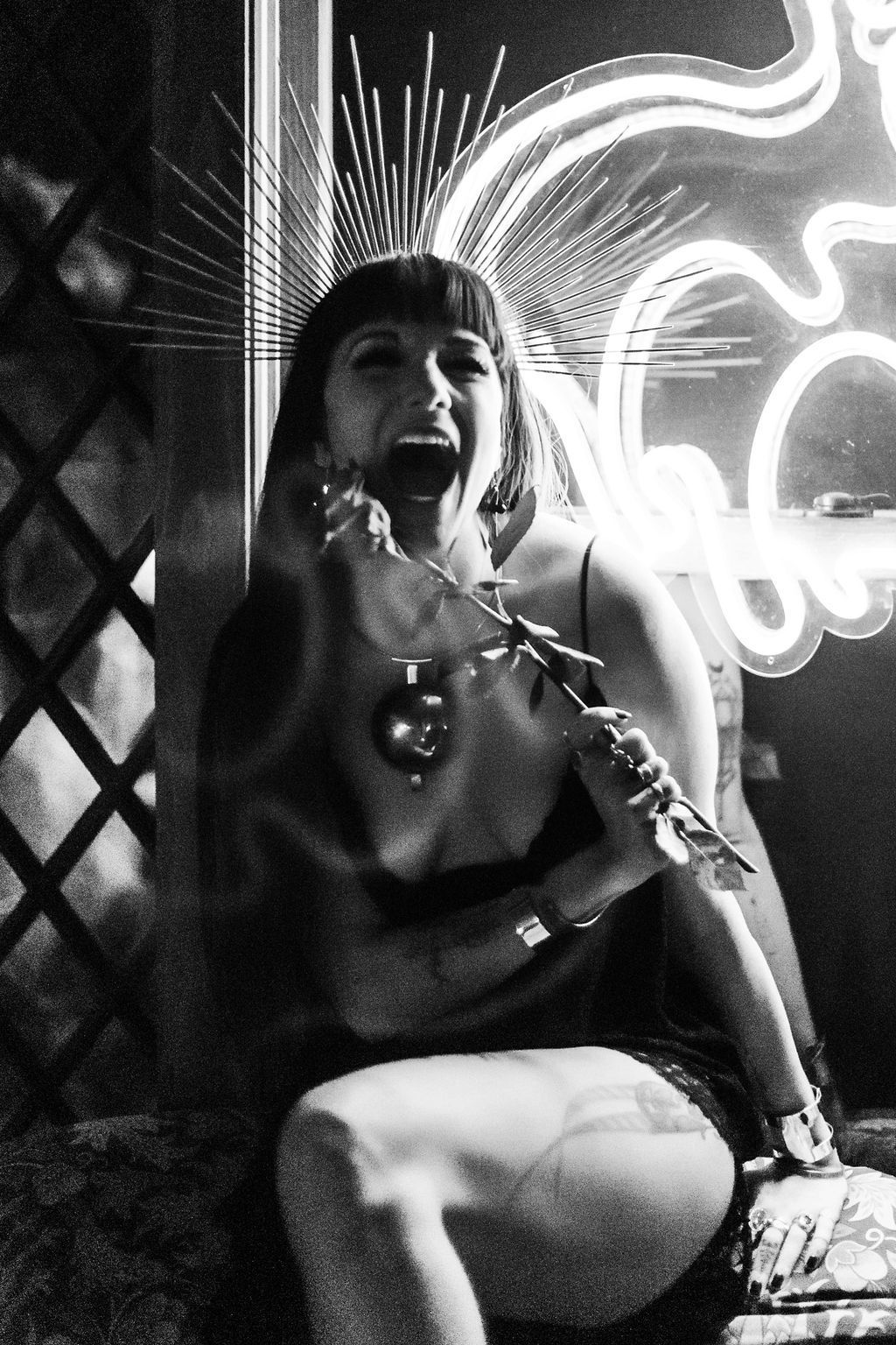 A black and white photo of a woman holding a rose