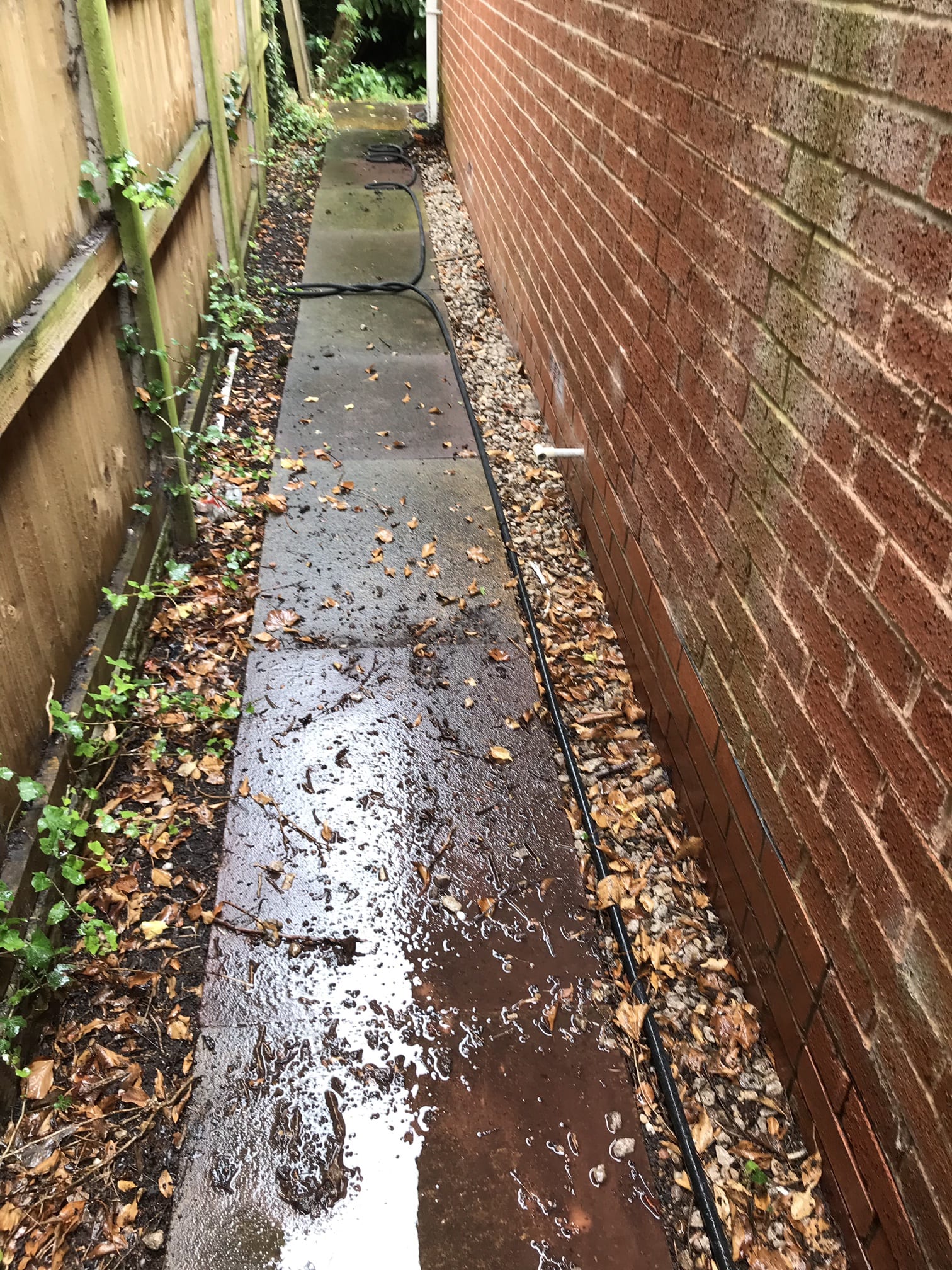 Dark paving slabs before cleaning