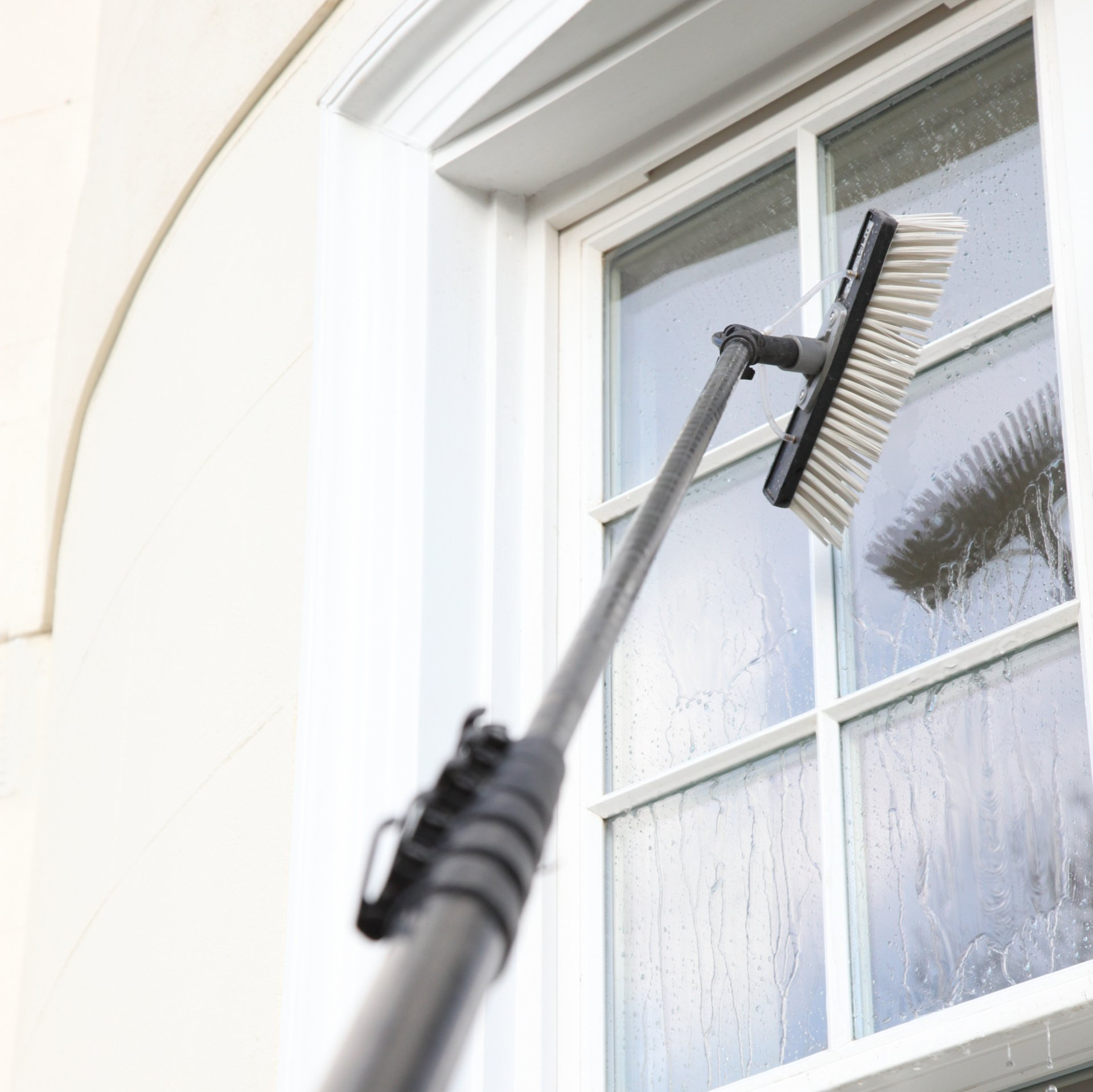 Window cleaning using the water fed pole system, also called reach and wash.