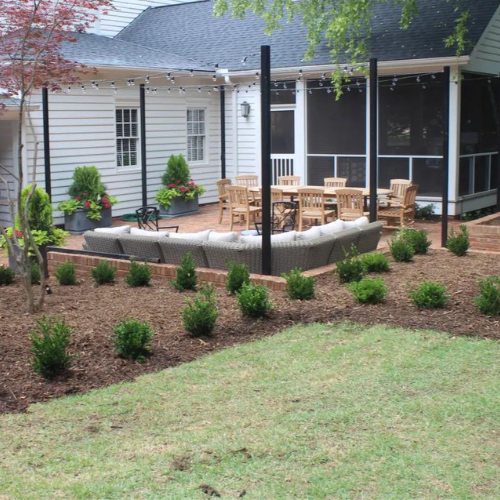 a screened in porch with a couch and chairs