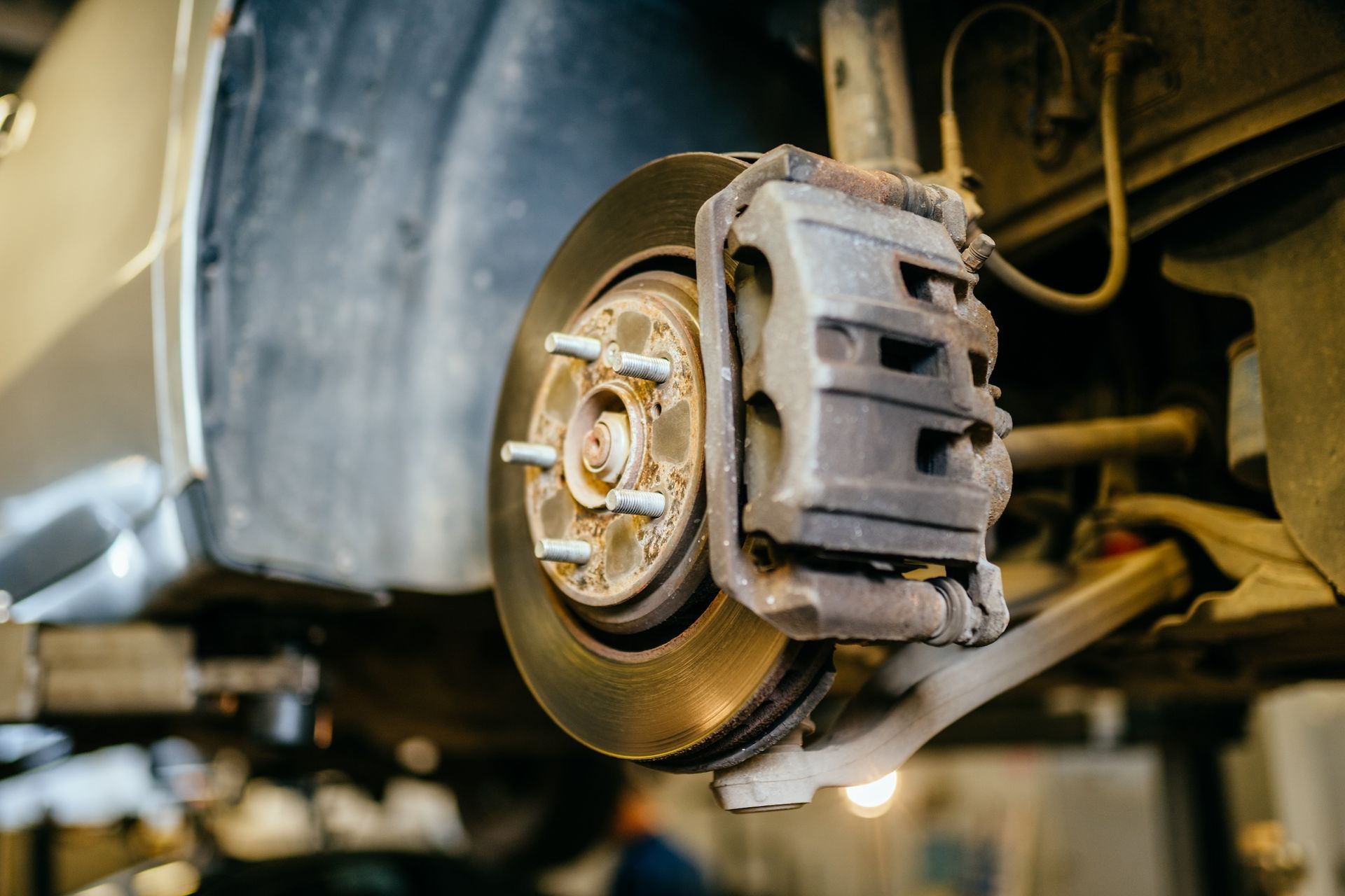 A close-up of a brake caliper on a car.