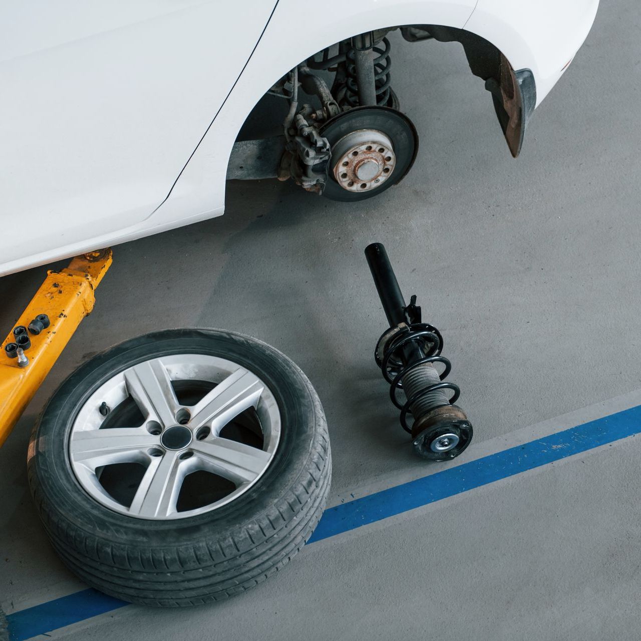 Car getting shocks replaced in an auto repair shop in Medford, Oregon.