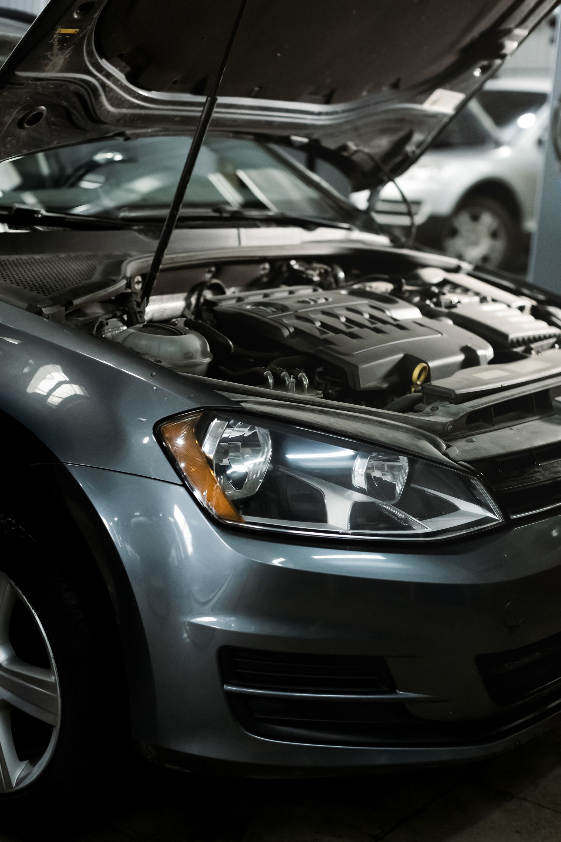 Car with the hood open at an auto repair shop in Medford, Oregon.