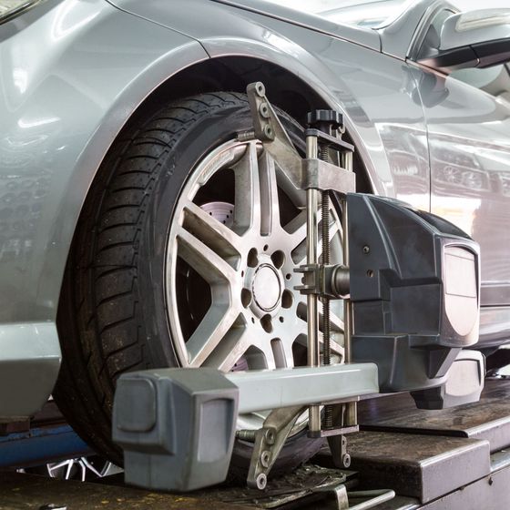 Close of a car tire on an alignment machine getting a 4-wheel alignment in Medford, Oregon.