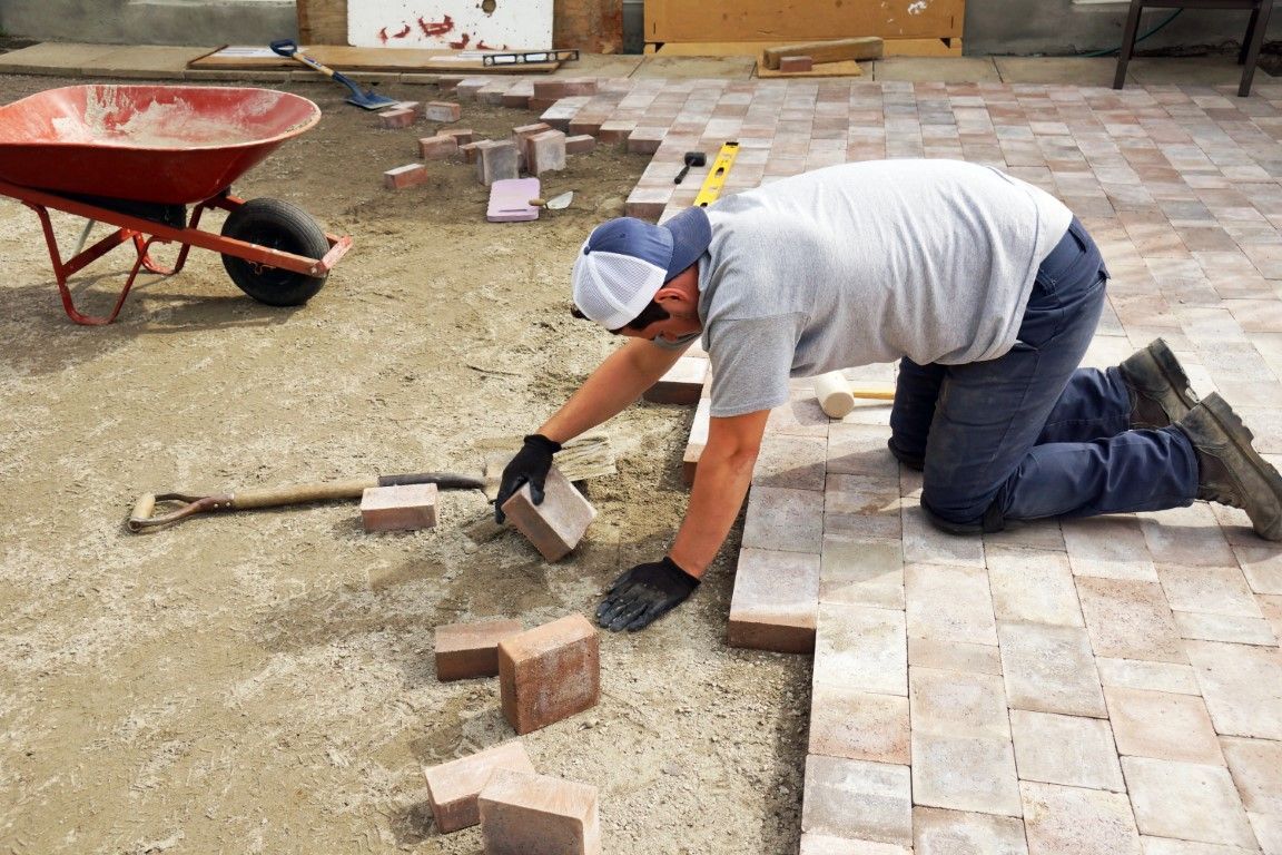 Photo of installer selecting which brick to lay down next.
