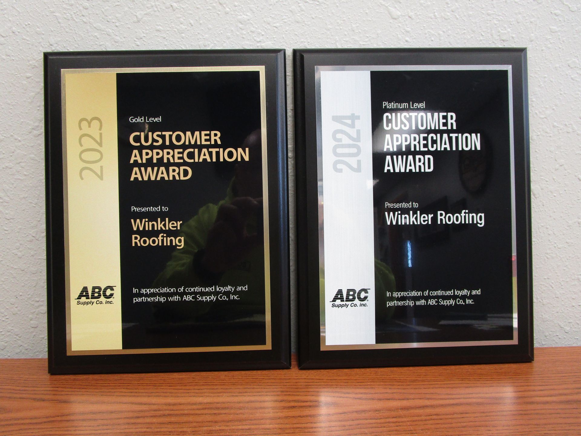 Two framed plaques that say customer appreciation award