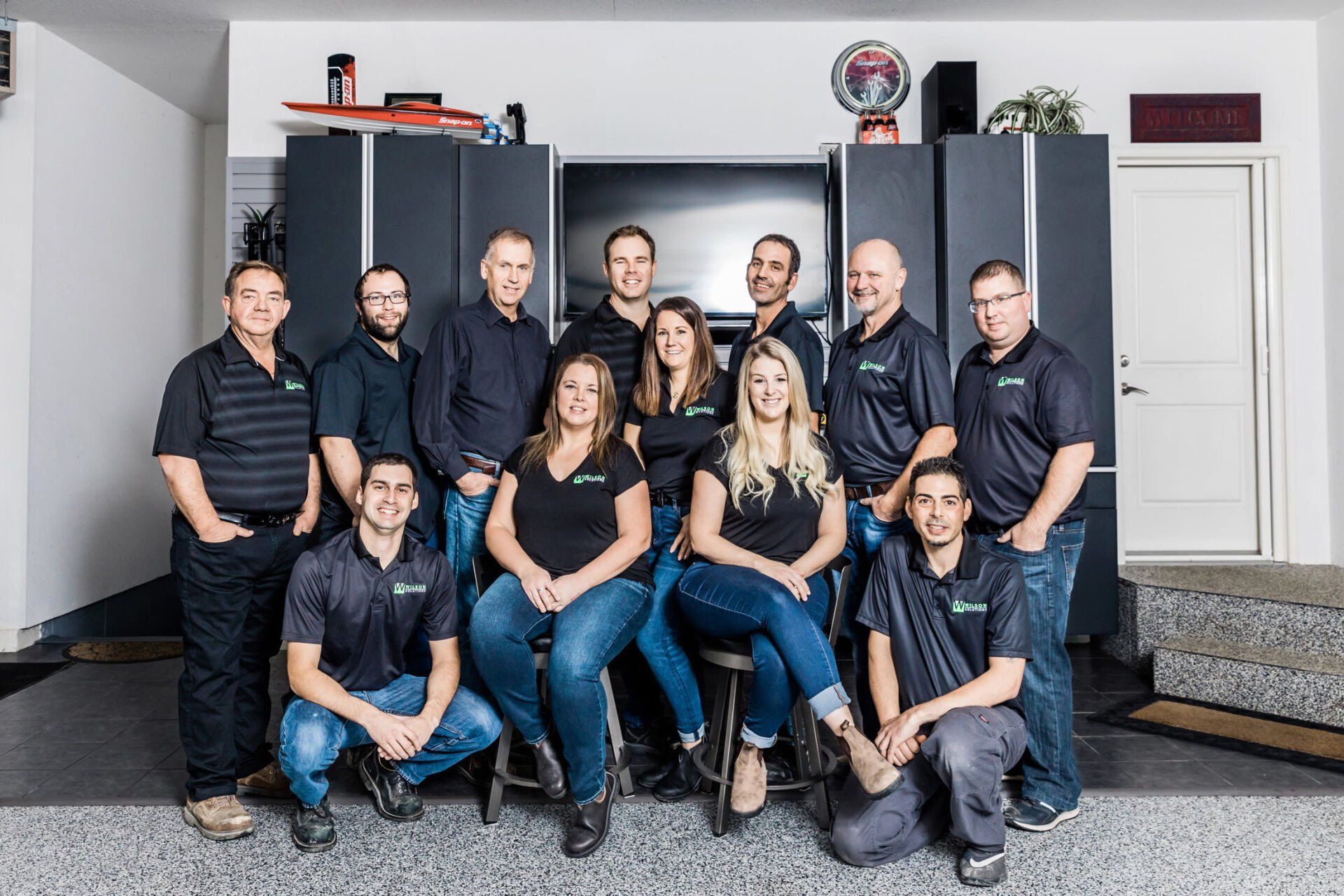 A group of people are posing for a picture in a garage.