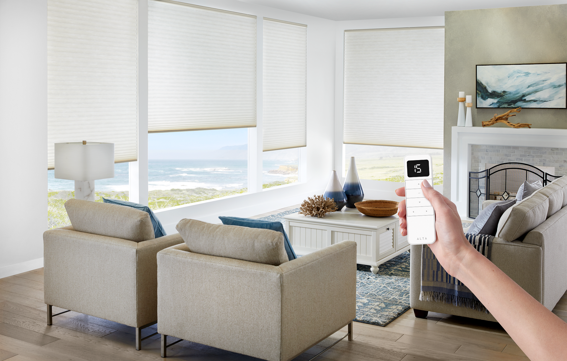 A person is holding a remote control in a living room.