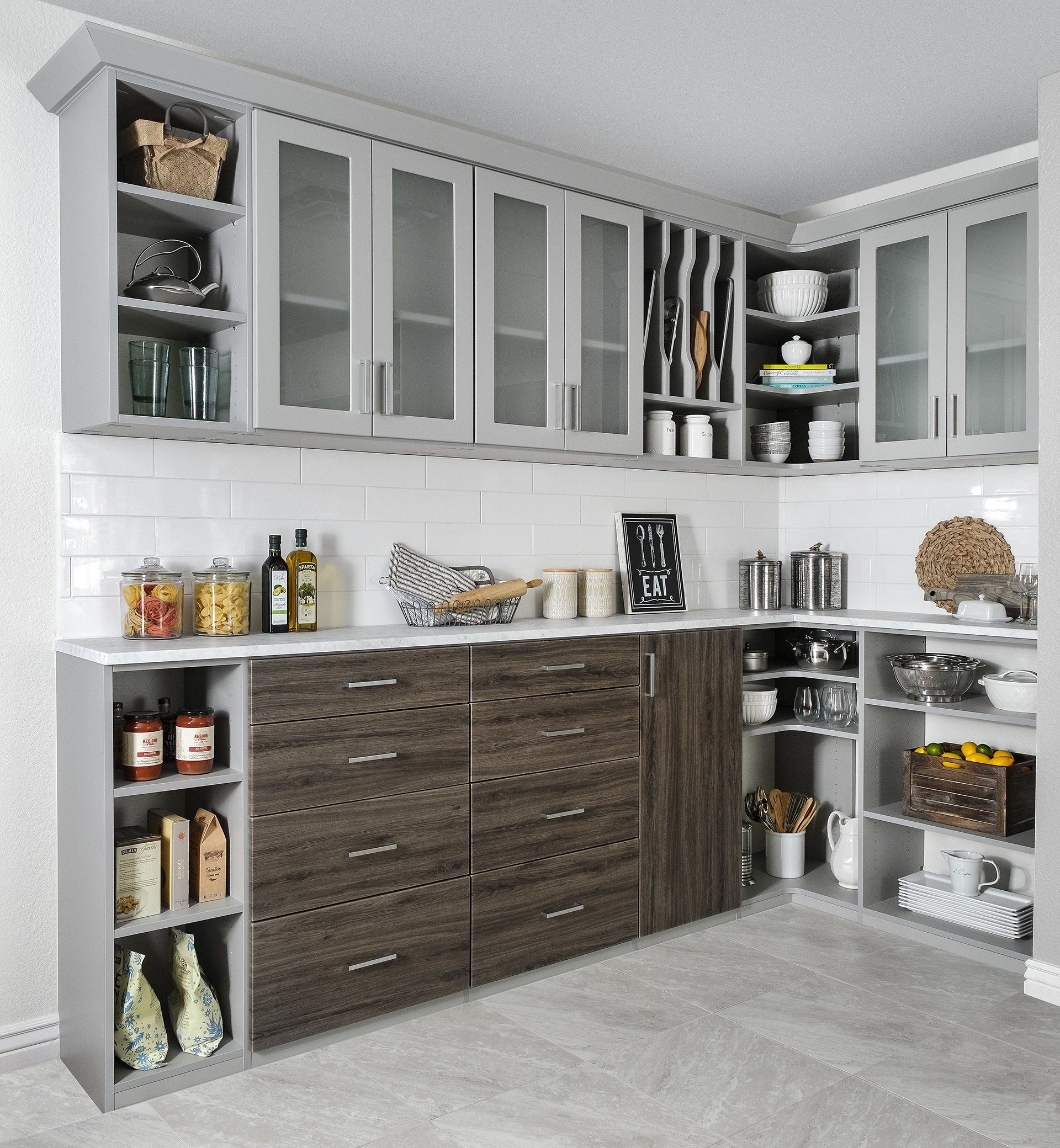 A kitchen with wooden cabinets and glass doors