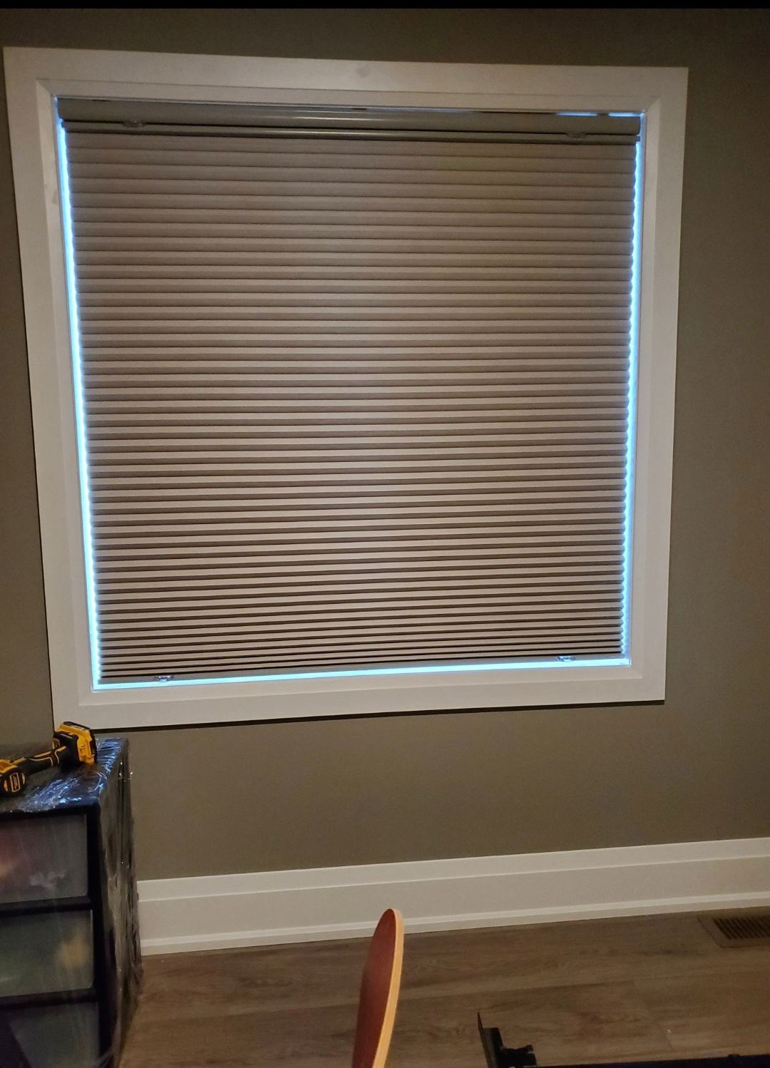 There is a window with blinds on it in a room.