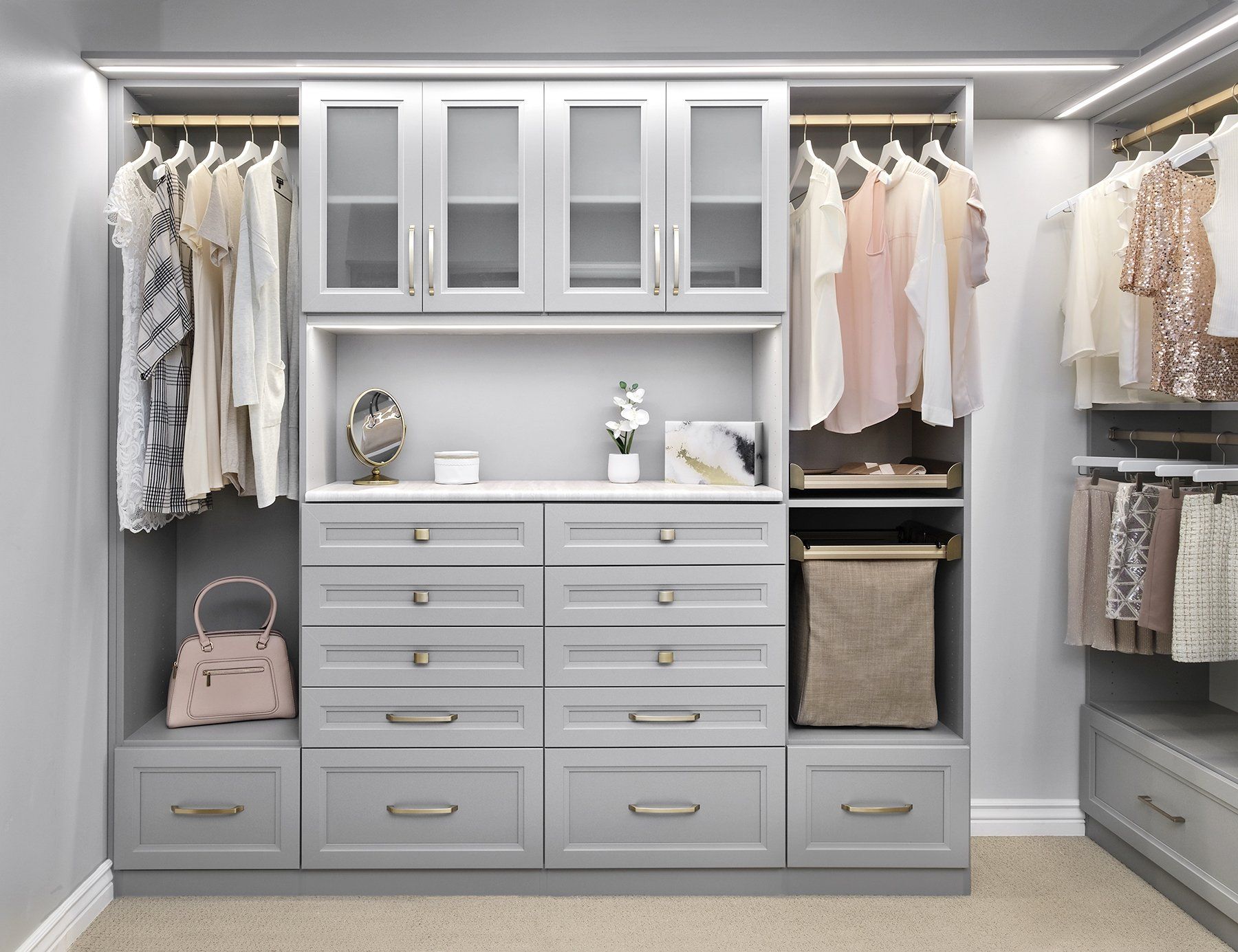 A walk in closet filled with lots of clothes and shoes.