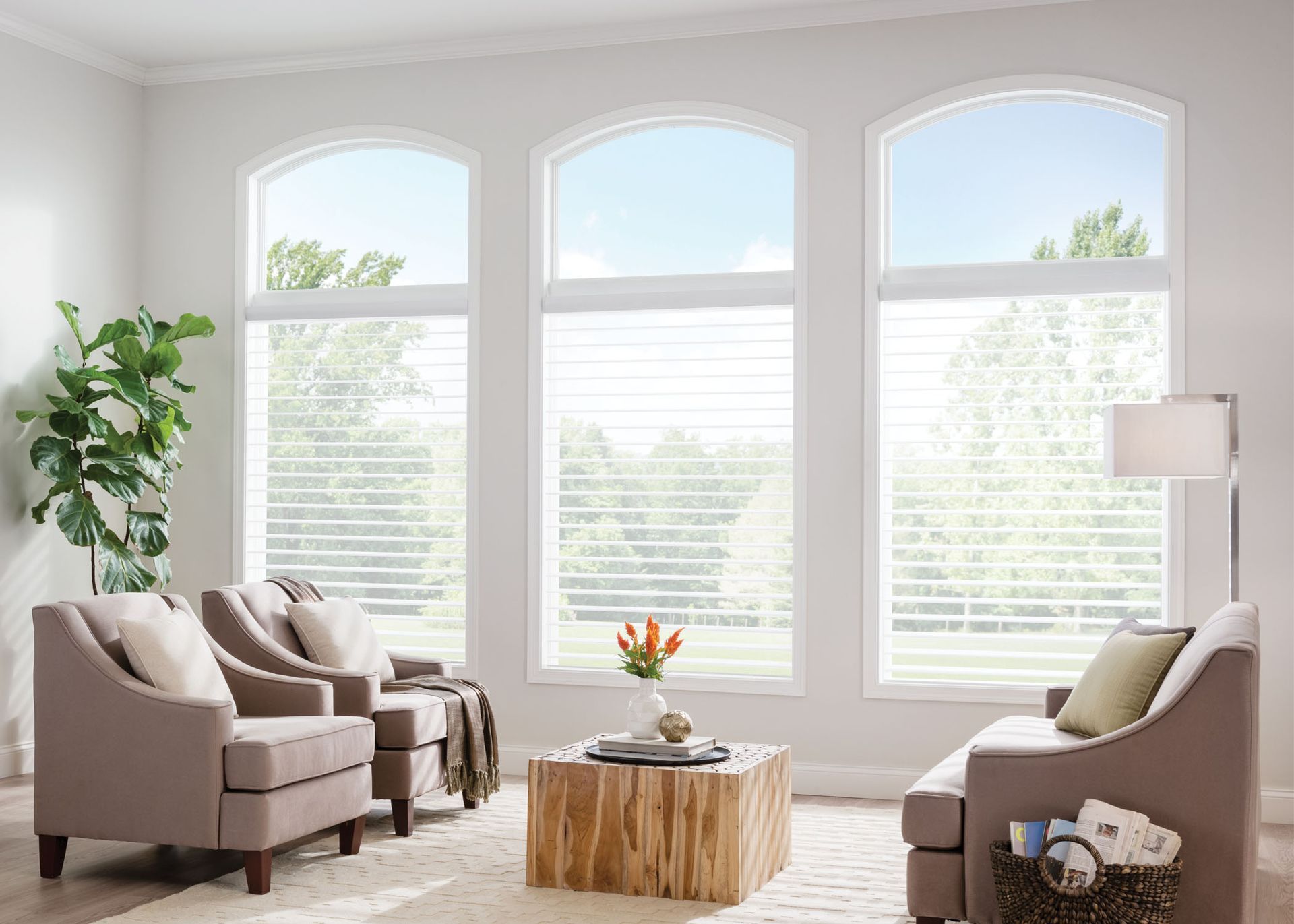 A living room with a couch , chairs , and a coffee table.