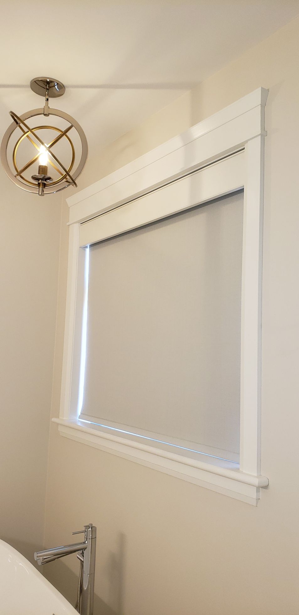 A bathroom with a sink and a window with blinds.