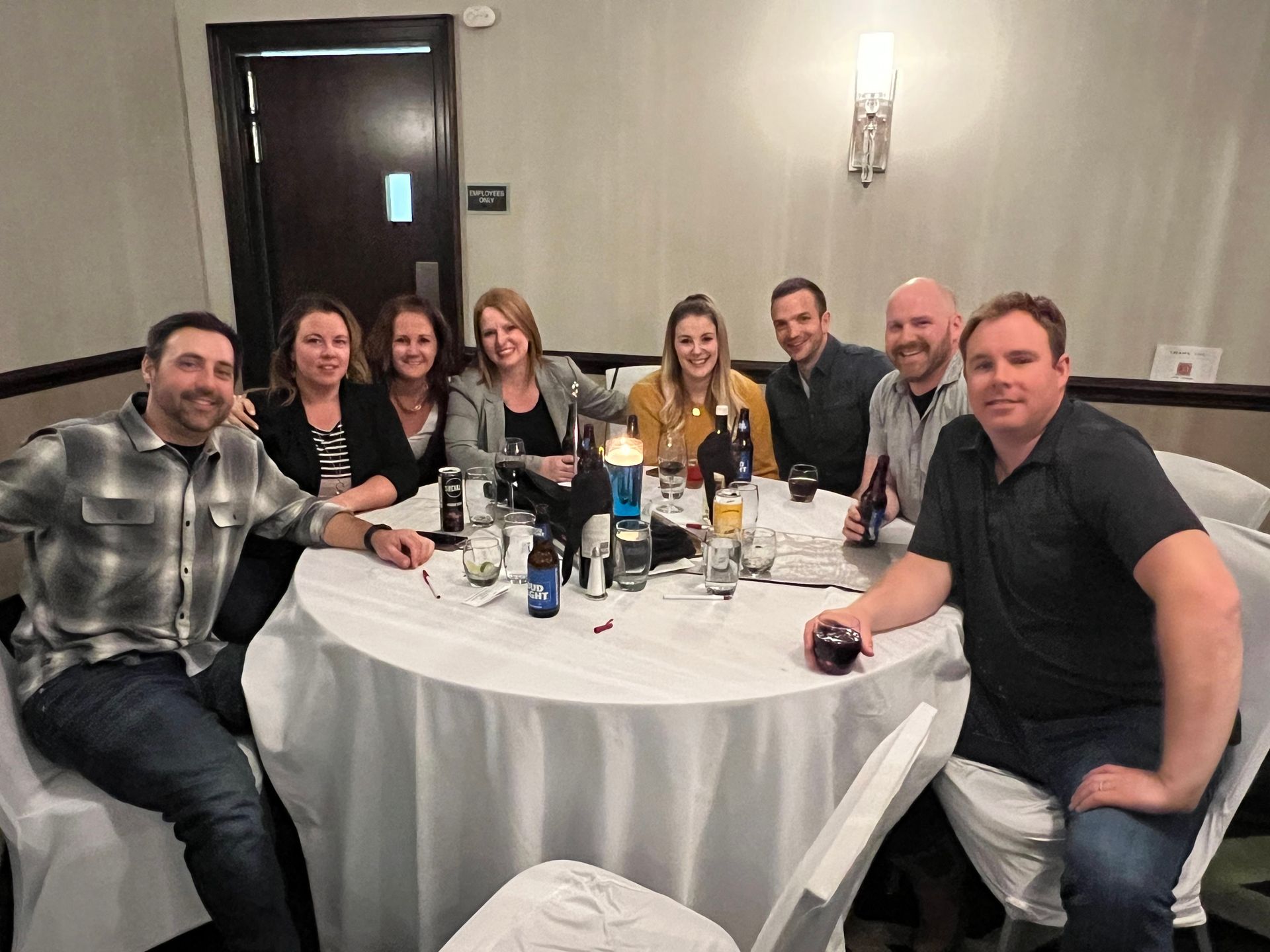 A group of people are sitting around a table in a room.