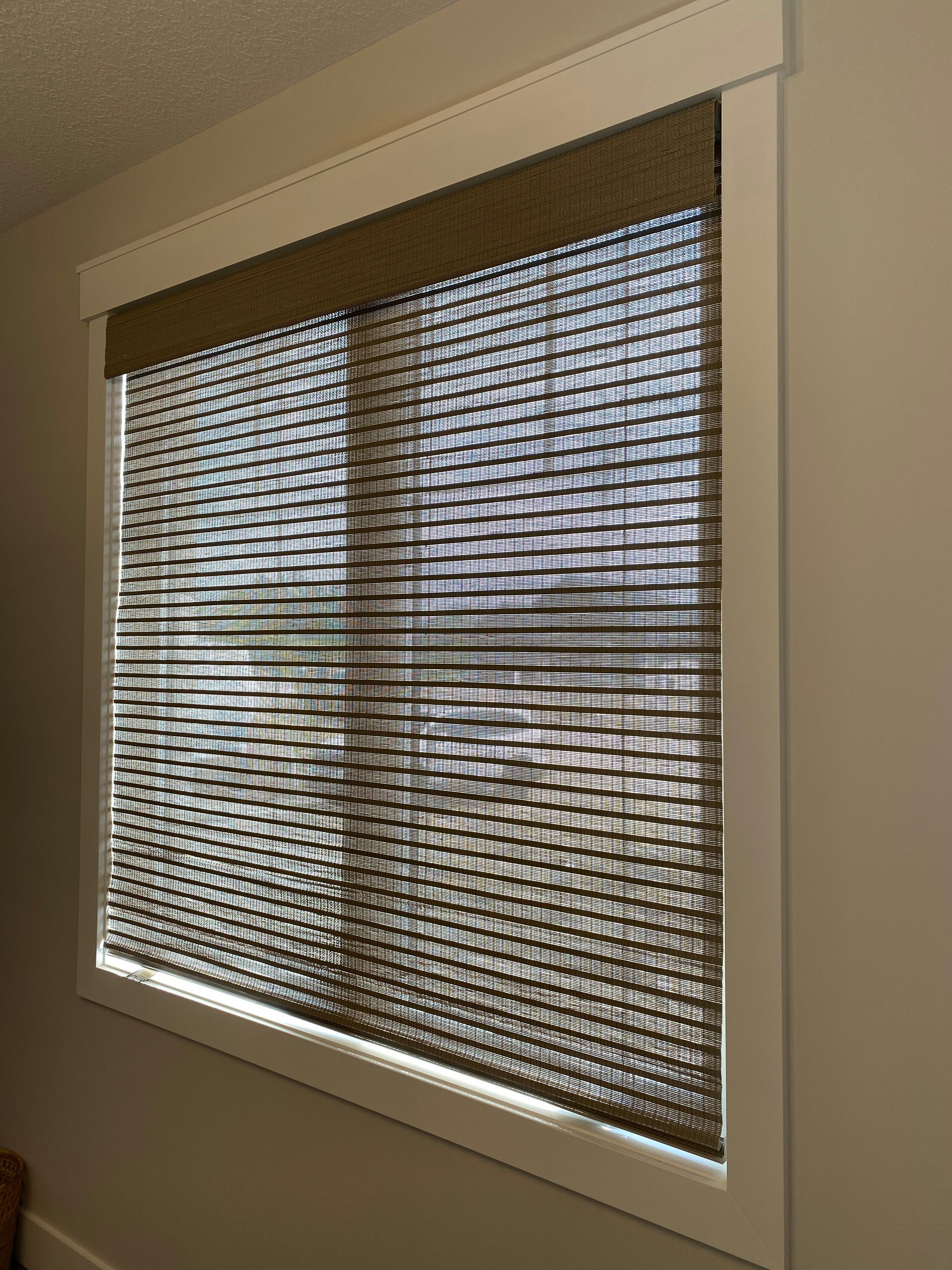 A window with blinds on it in a room.