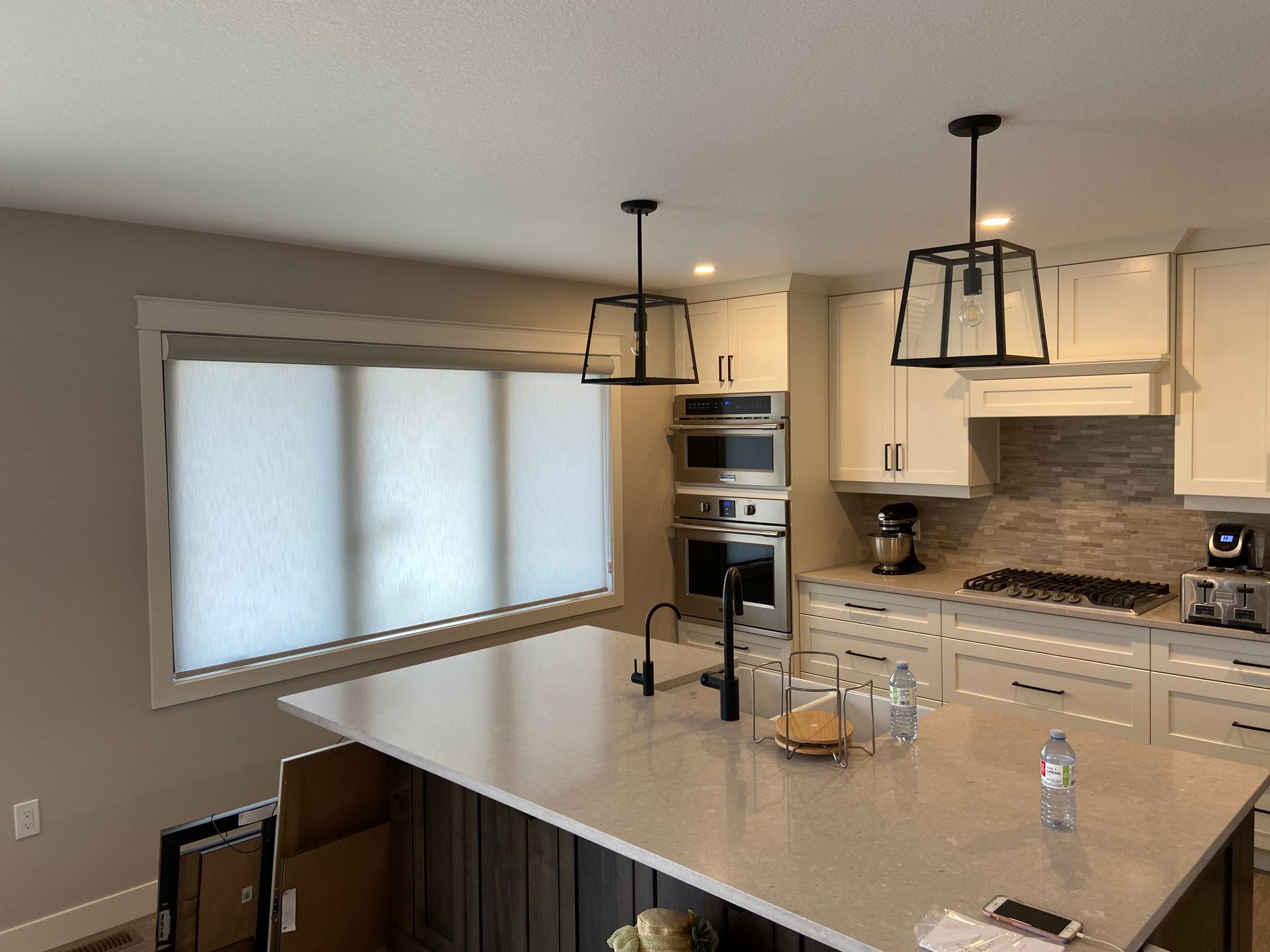 A kitchen with a large island and white cabinets