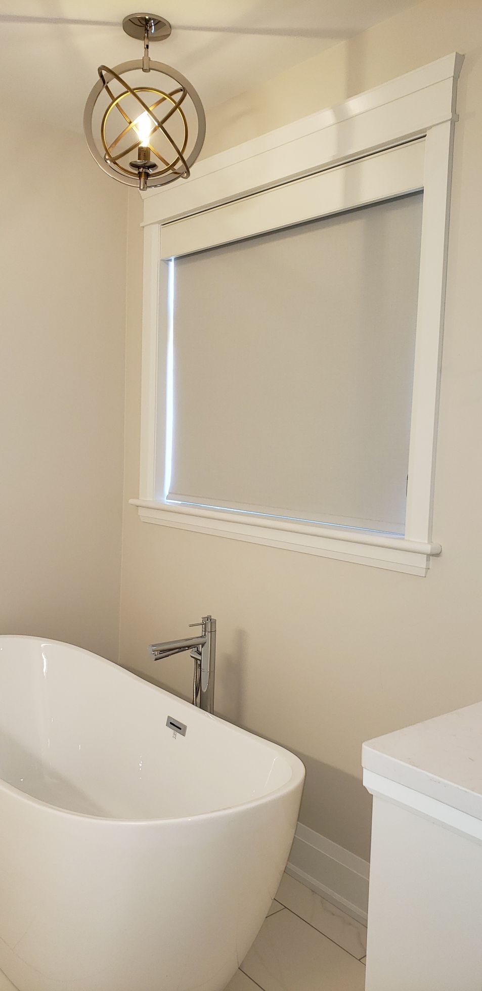 A bathroom with a bathtub , toilet and window.