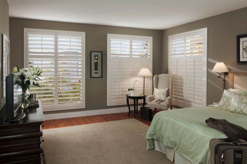 A bedroom with a bed , chair , table and television.