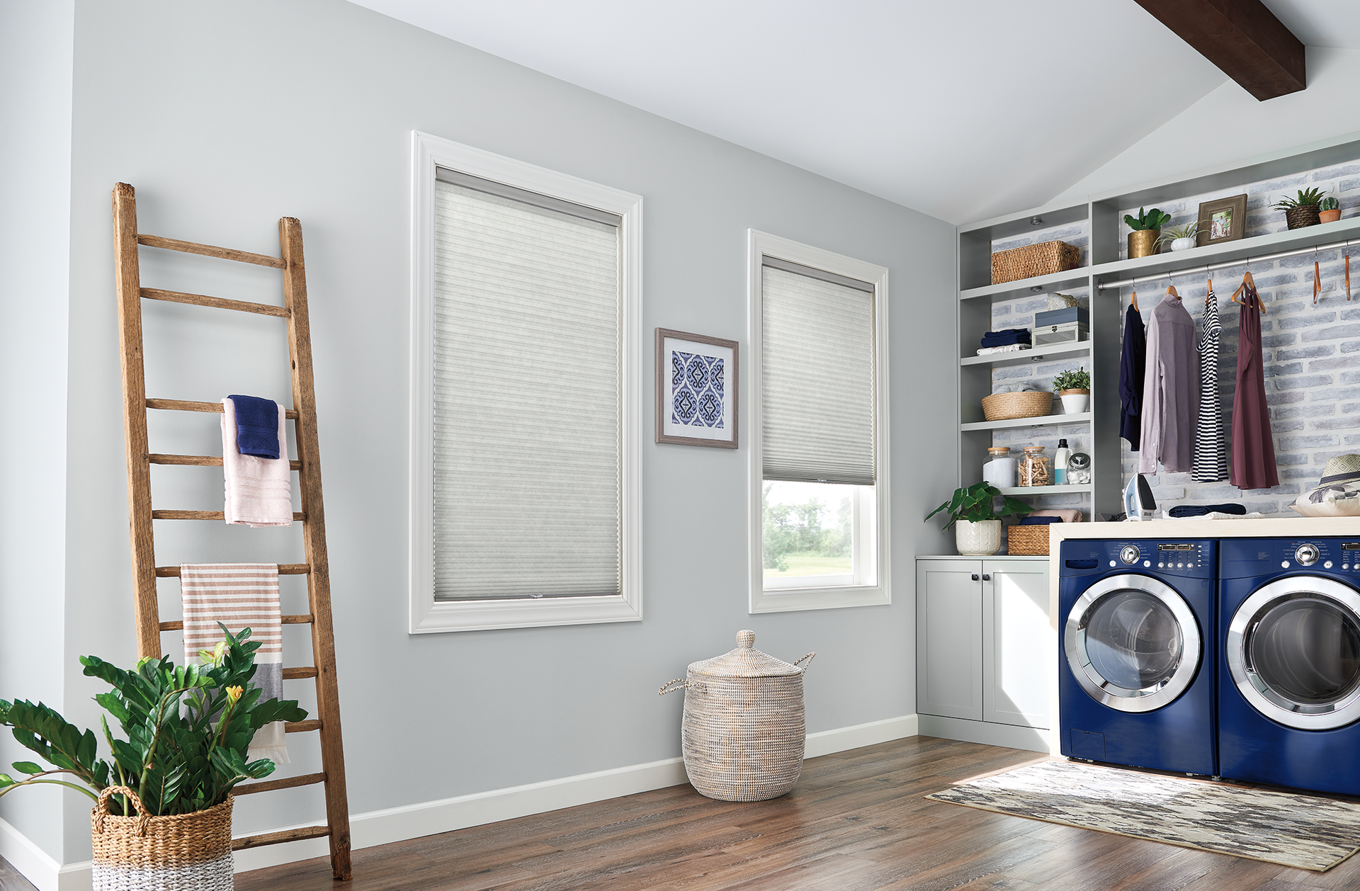 A laundry room with a ladder , washer and dryer , and shelves.