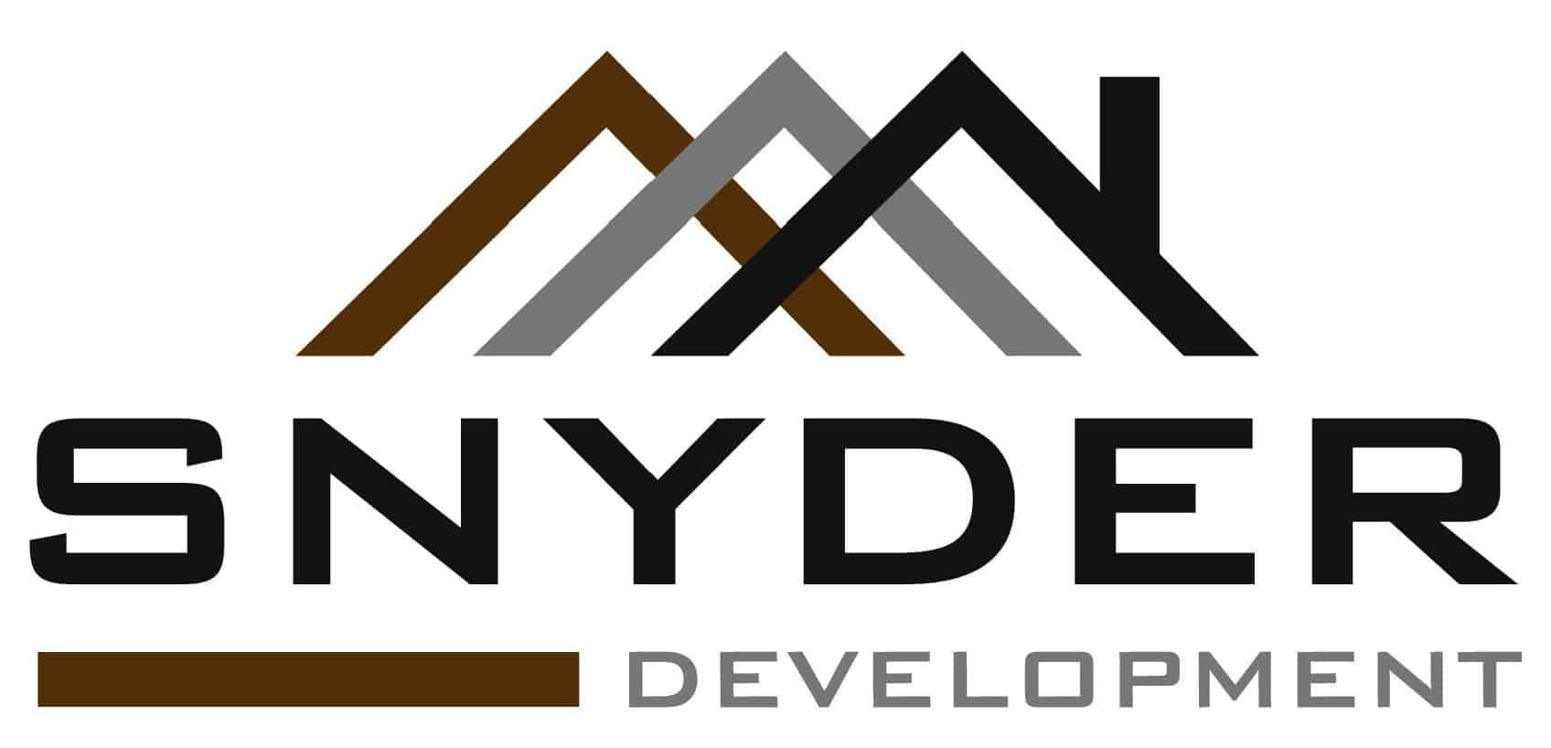 A logo for snyder development with a mountain in the background.