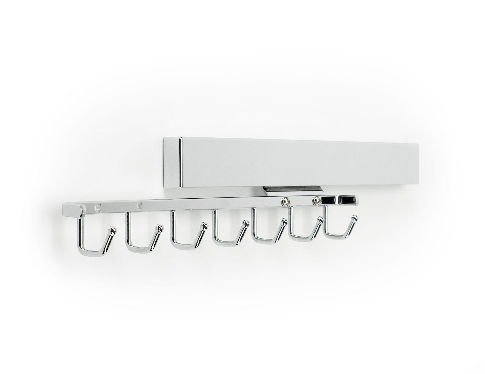 A white wall mounted coat rack with hooks on it.