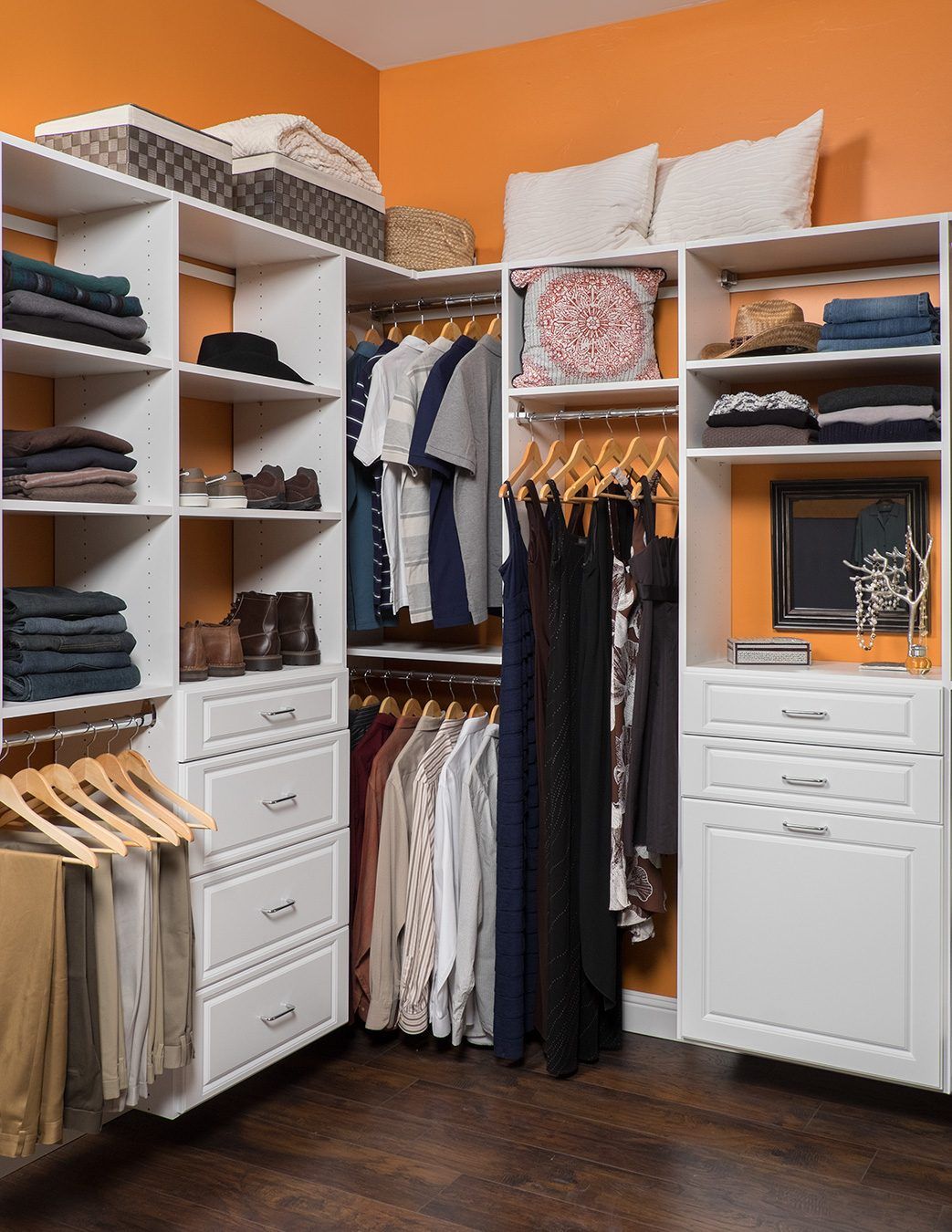 A walk in closet filled with clothes and drawers