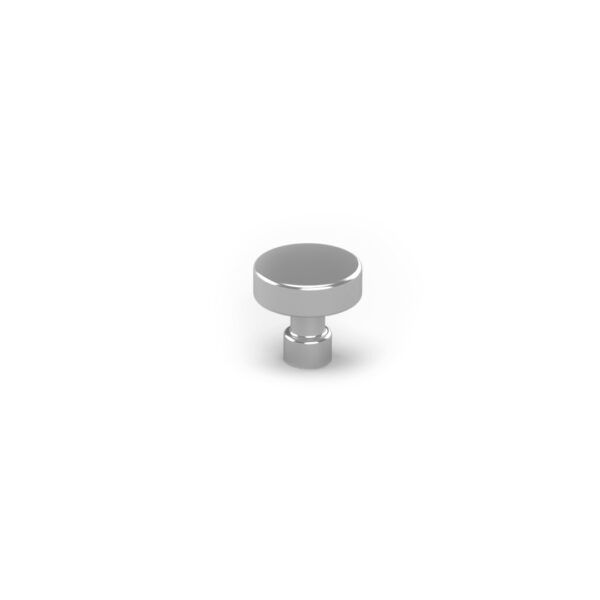 A small metal object is sitting on a white surface.