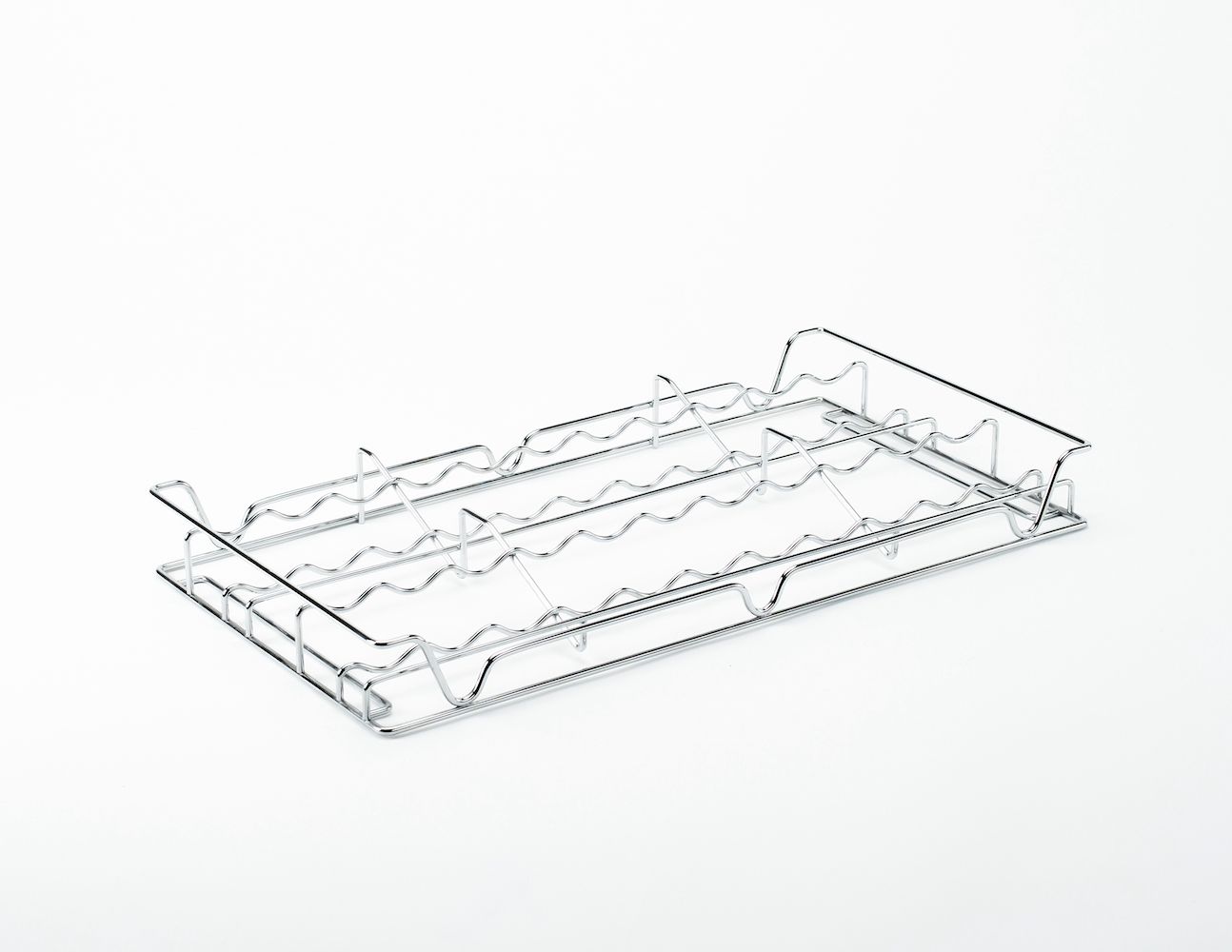 A metal tray with a handle on a white surface.