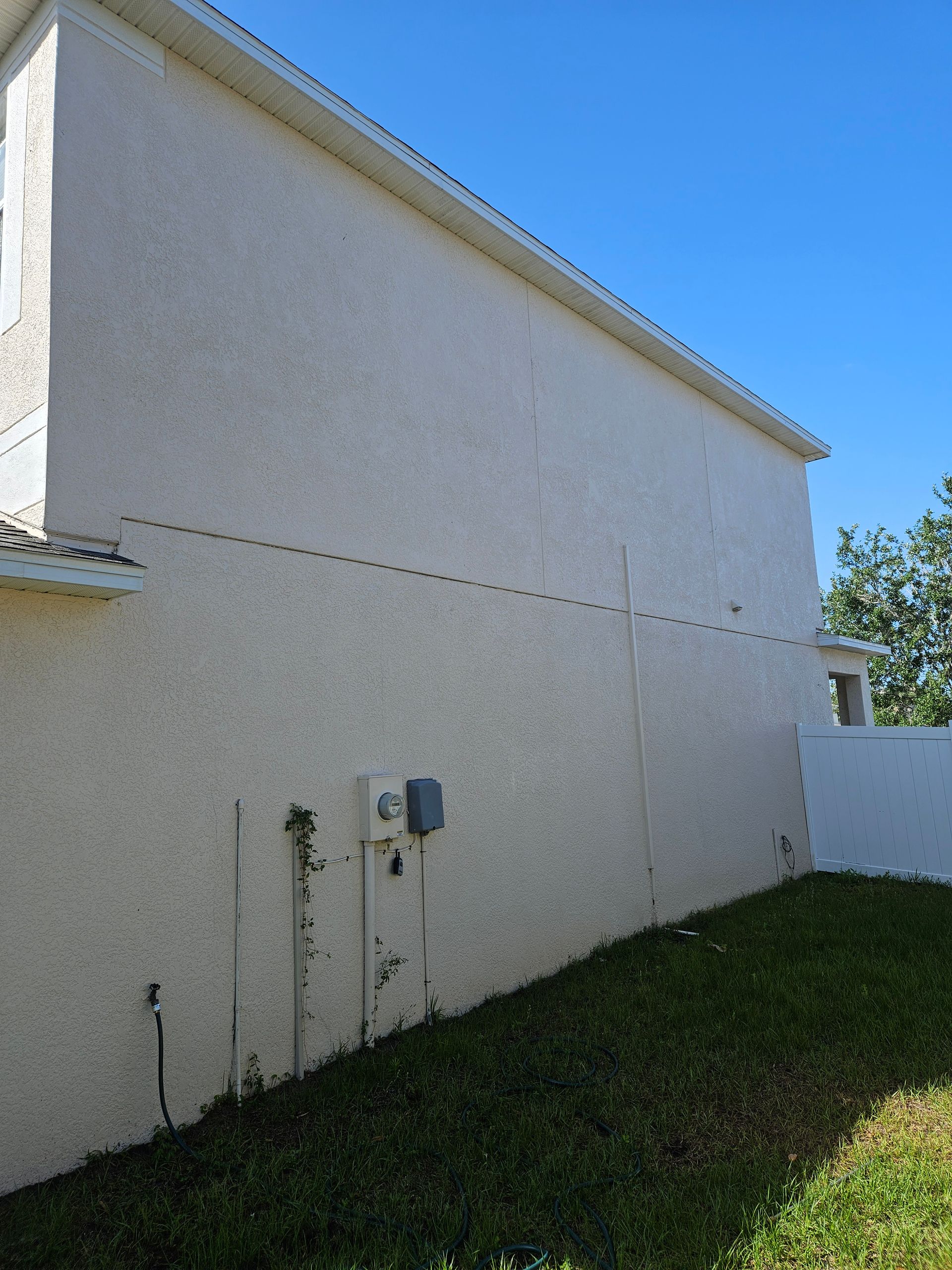 A white building with a blue sky in the background